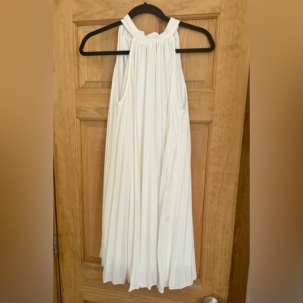 White mini pleated dress with halter top neckline. size Medium.